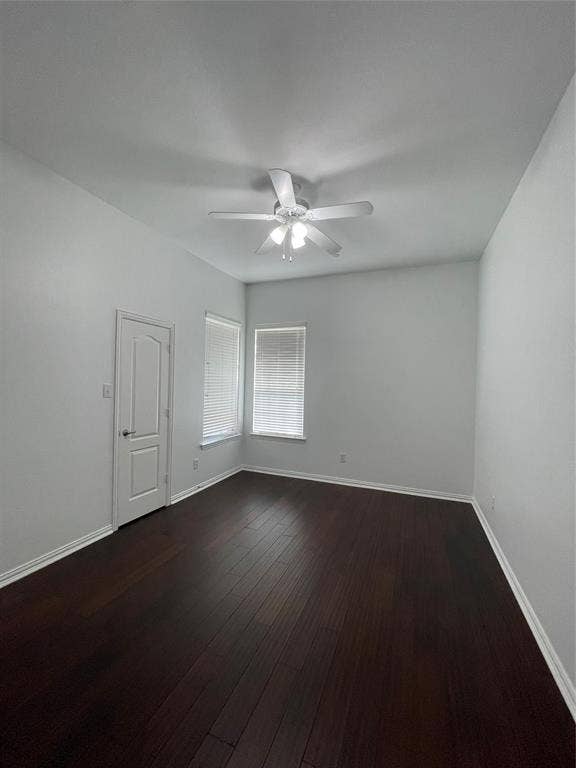 1944 Loma Linda Drive, Irving, TX 75063 Interior room featuring dark wood-finish flooring, neutral wall tones, a multi-blade ceiling fan with integrated lighting, and two windows with horizontal blinds