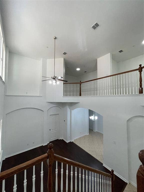 1944 Loma Linda Drive, Irving, TX 75063 Double-height ceiling featuring an expansive open layout, wood-finish flooring, architectural arched niches, and a wooden staircase railing with white balusters