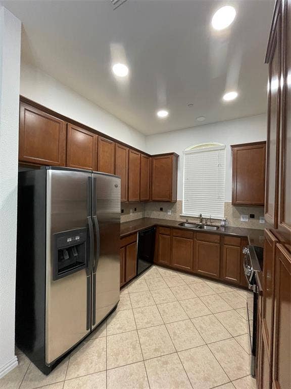 1944 Loma Linda Drive, Irving, TX 75063 Kitchen featuring shaker-style wood cabinetry, stainless steel appliances, dark countertops, a double-basin sink, and tile flooring