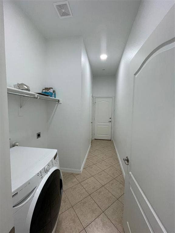 1944 Loma Linda Drive, Irving, TX 75063 Laundry area featuring tile flooring, a built-in metal shelving unit, and a door with raised-panel detailing