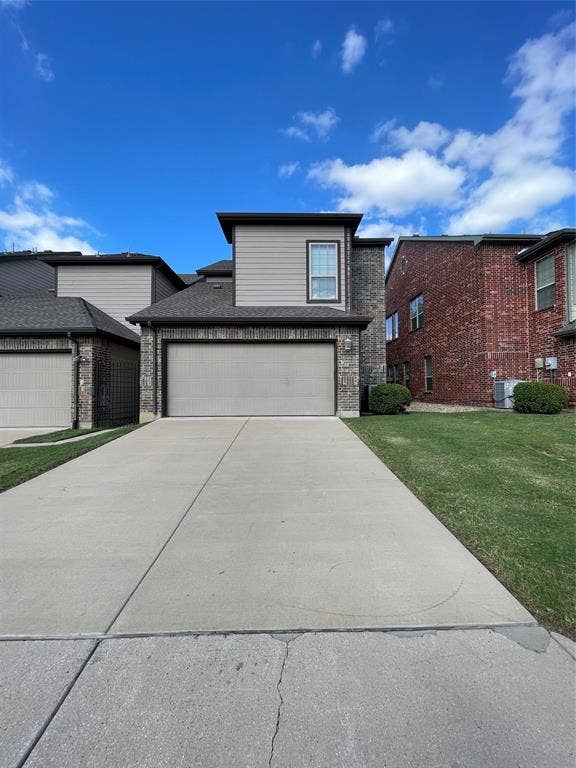 1944 Loma Linda Drive, Irving, TX 75063 Multi-level exterior featuring a combination of brick and horizontal siding, an attached two-car garage, and a concrete driveway