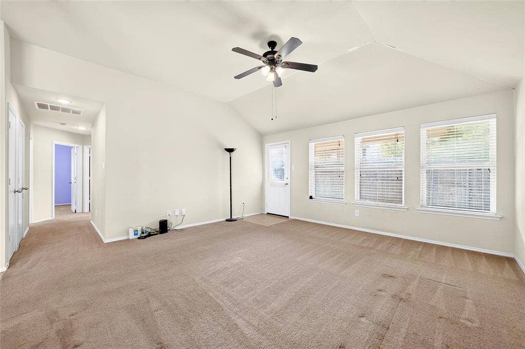 8448 Little Fawn Lane, Dallas, TX 75249 Vaulted ceilings featuring a central ceiling fan and three large windows with horizontal blinds