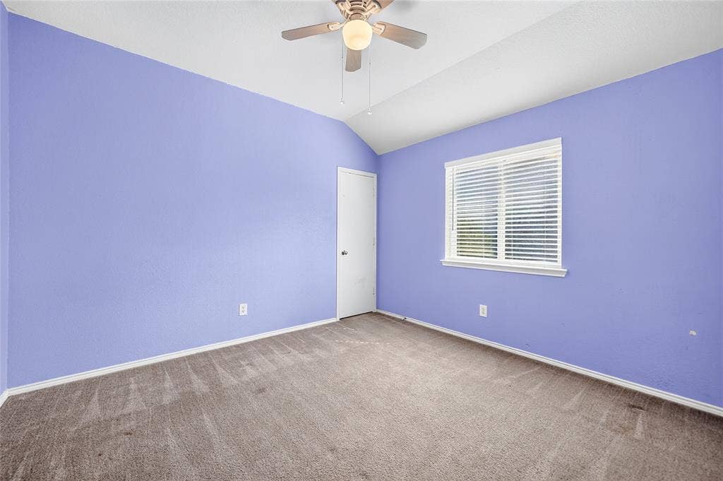 8448 Little Fawn Lane, Dallas, TX 75249 Bedroom featuring vaulted ceilings, neutral-toned carpeting, a ceiling fan with integrated lighting, and a window with horizontal blinds