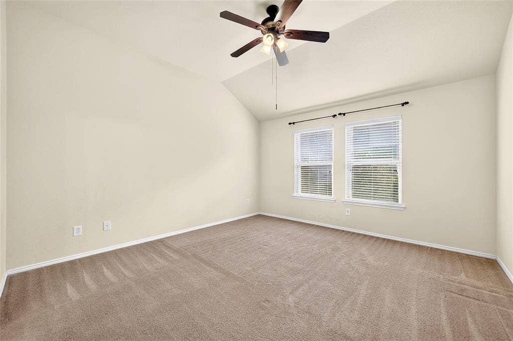 8448 Little Fawn Lane, Dallas, TX 75249 Vaulted ceiling, neutral wall tones, wall-to-wall carpeting, ceiling fan with light fixture, and dual windows with horizontal blinds