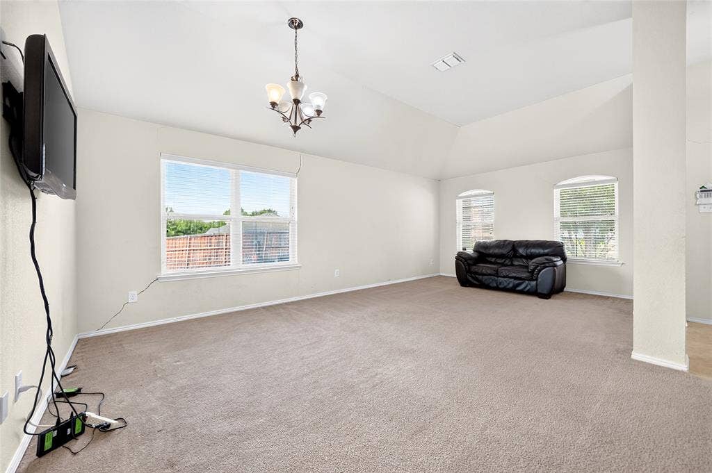8448 Little Fawn Lane, Dallas, TX 75249 Vaulted ceilings, multi-pane windows, and a classic central chandelier