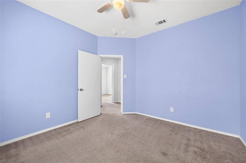 8448 Little Fawn Lane, Dallas, TX 75249 Neutral-toned wall finish featuring carpeted flooring and a mounted ceiling fan with integrated lighting