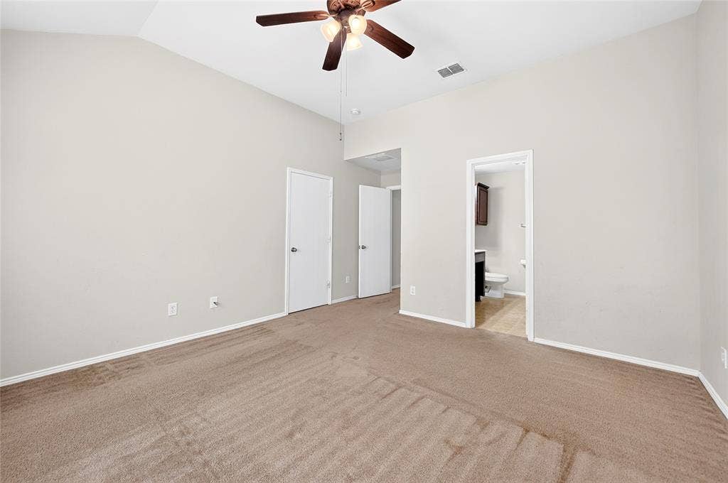 8448 Little Fawn Lane, Dallas, TX 75249 Vaulted ceiling featuring a central multi-blade ceiling fan with integrated lighting and wall-to-wall carpeting