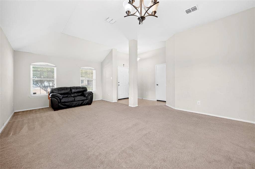 8448 Little Fawn Lane, Dallas, TX 75249 Vaulted ceilings, arched windows, neutral wall palette, carpeted flooring, and a multi-arm chandelier