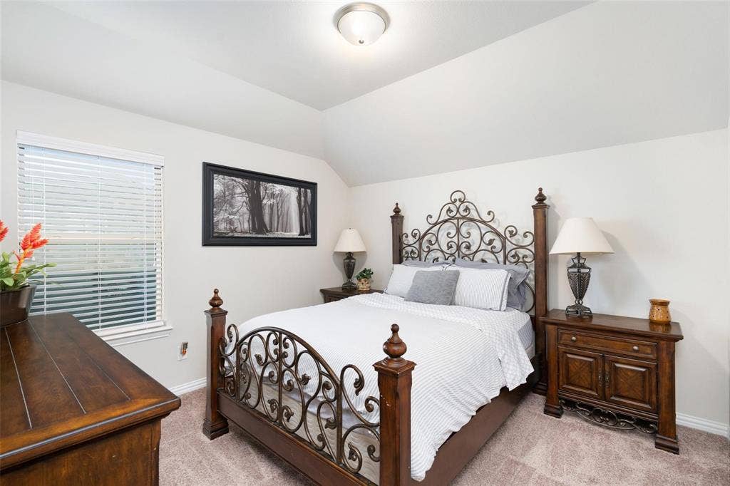 1017 Hoyt Drive, McKinney, TX 75071 Vaulted ceiling, window with blinds, and neutral-toned carpeting