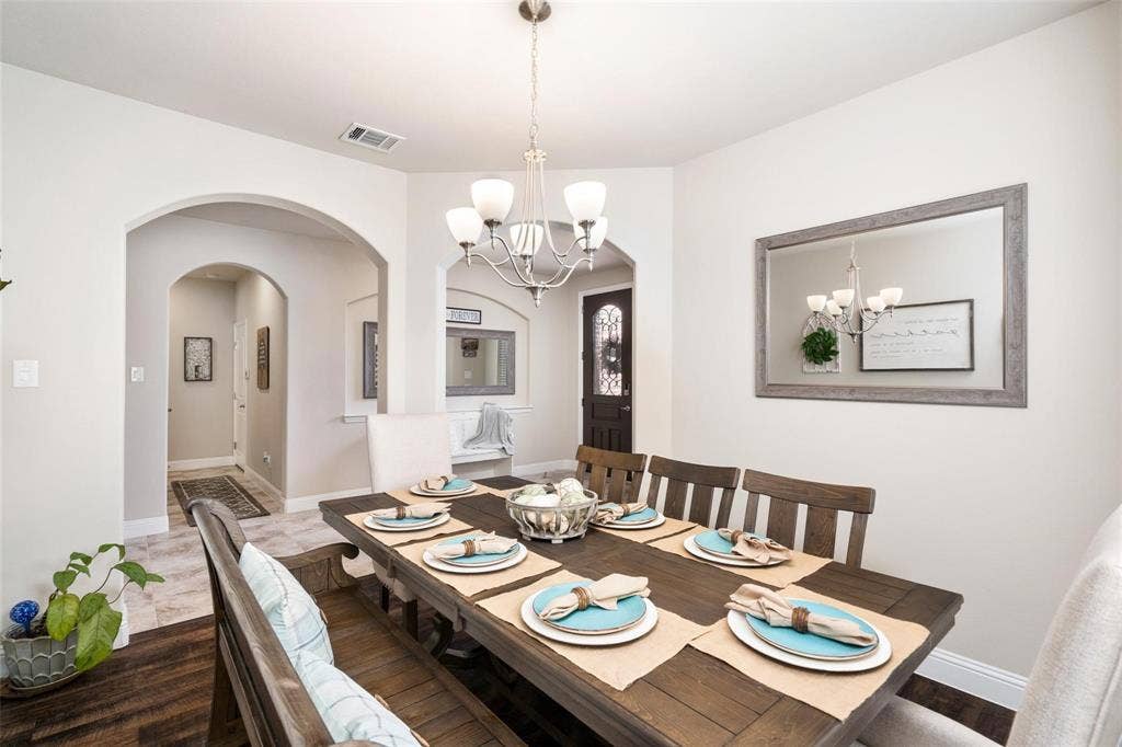 1017 Hoyt Drive, McKinney, TX 75071 Recessed lighting, arched doorways, wood-finish flooring, tile flooring, and a chandelier