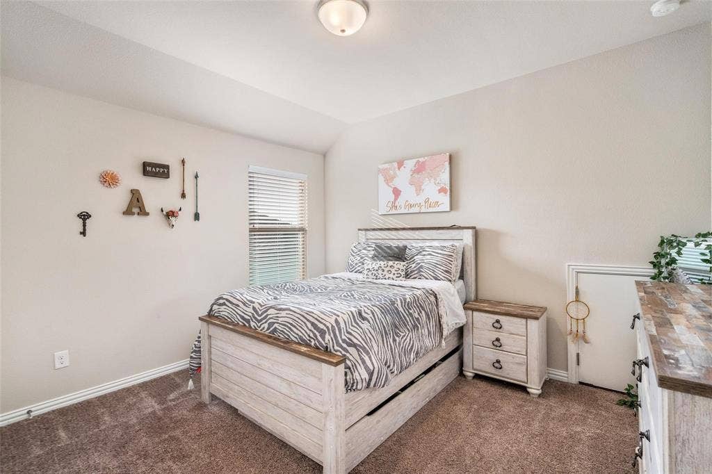1017 Hoyt Drive, McKinney, TX 75071 Neutral-toned walls complement the textured carpet flooring