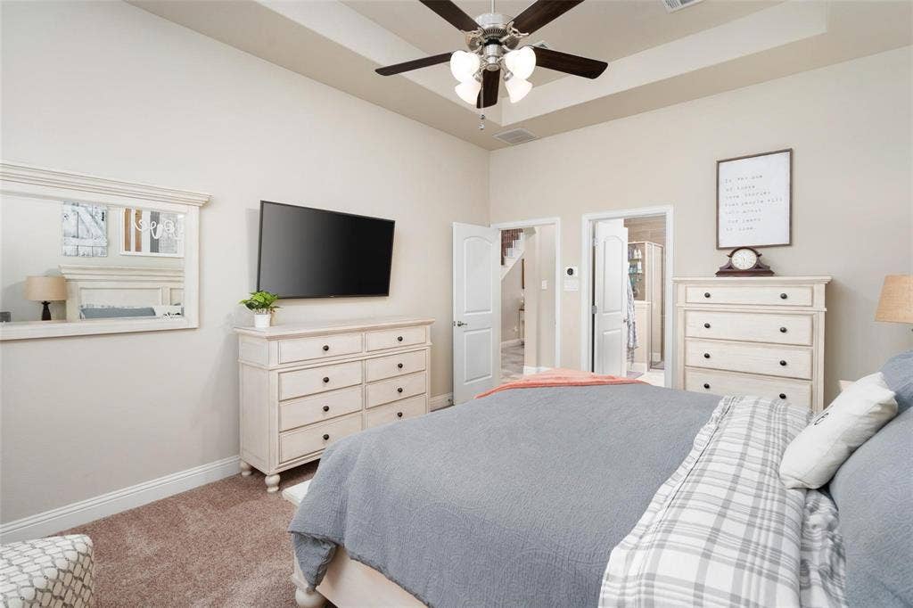 1017 Hoyt Drive, McKinney, TX 75071 Recessed ceiling with an overhead fan light fixture, light-toned wall paint, and plush carpet flooring