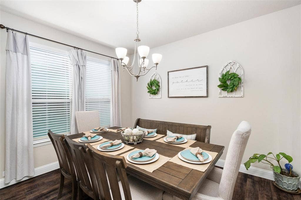 1017 Hoyt Drive, McKinney, TX 75071 Recessed dining area with a chandelier and two windows featuring blinds