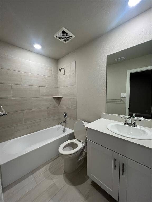 5908 Brittner Drive, Princeton, TX 75071 Bathtub with tiled surround, single vanity with integrated sink, and coordinated floor tiling