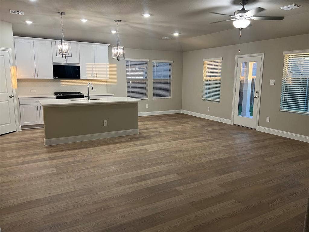 5908 Brittner Drive, Princeton, TX 75071 Open-concept living space with wood-finish flooring, recessed lighting, and a ceiling fan