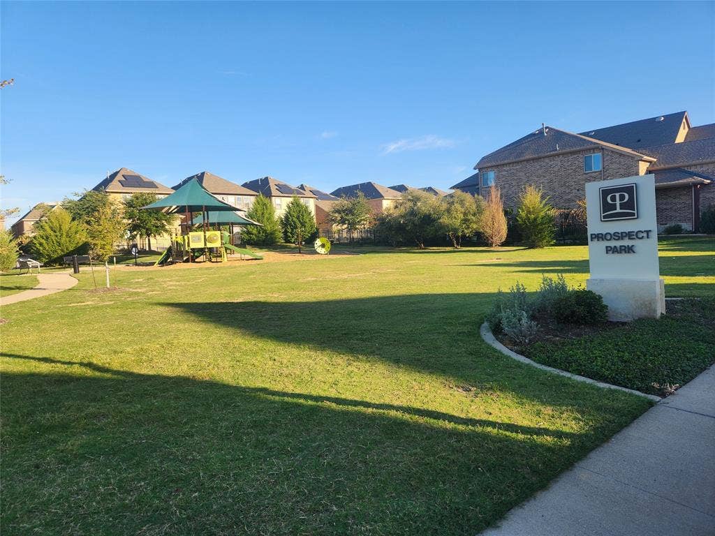3038 Ivy Hill Lane, Irving, TX 75063 Community park featuring green space, playground structure with shaded canopy, walking paths, and a prominent "Prospect Park" entrance sign