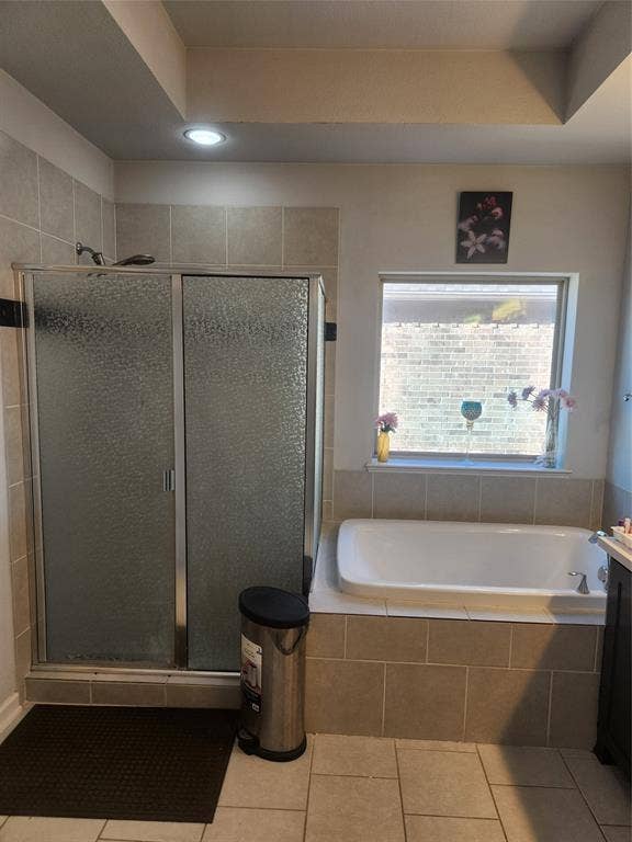 3038 Ivy Hill Lane, Irving, TX 75063 Full bathroom featuring a walk-in shower with sliding frosted glass doors, an inset bathtub, and tiled flooring