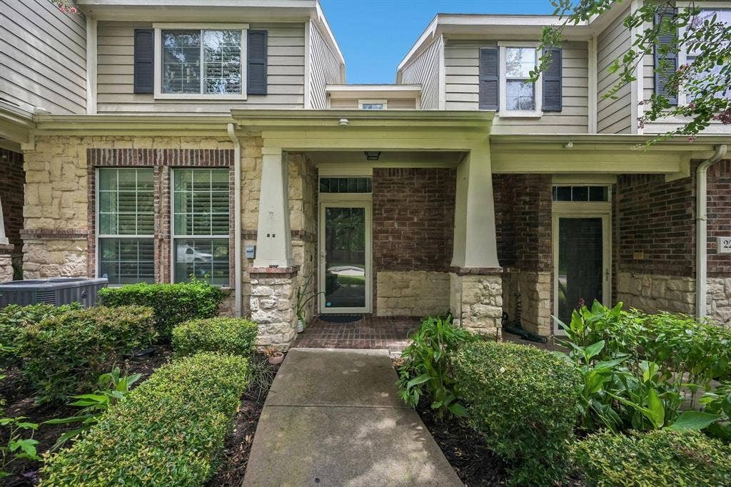 2209 Stonepark Place, McKinney, TX 75071 Multi-level residence featuring a brick and stone facade, covered entry, and upper-level siding