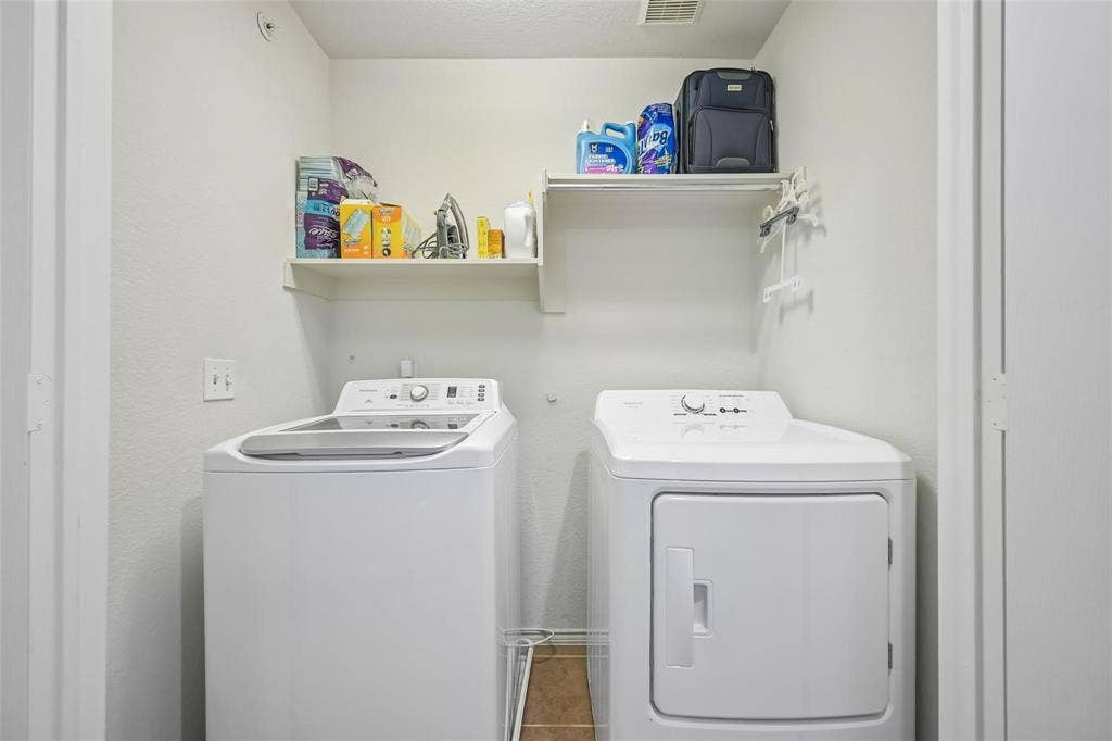 2209 Stonepark Place, McKinney, TX 75071 Laundry area featuring shelving and a clothes drying rack