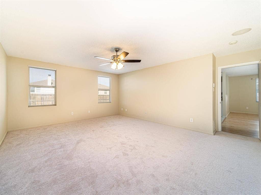 Carpeted flooring, ceiling fan with integrated lighting, recessed ceiling speakers, and dual windows