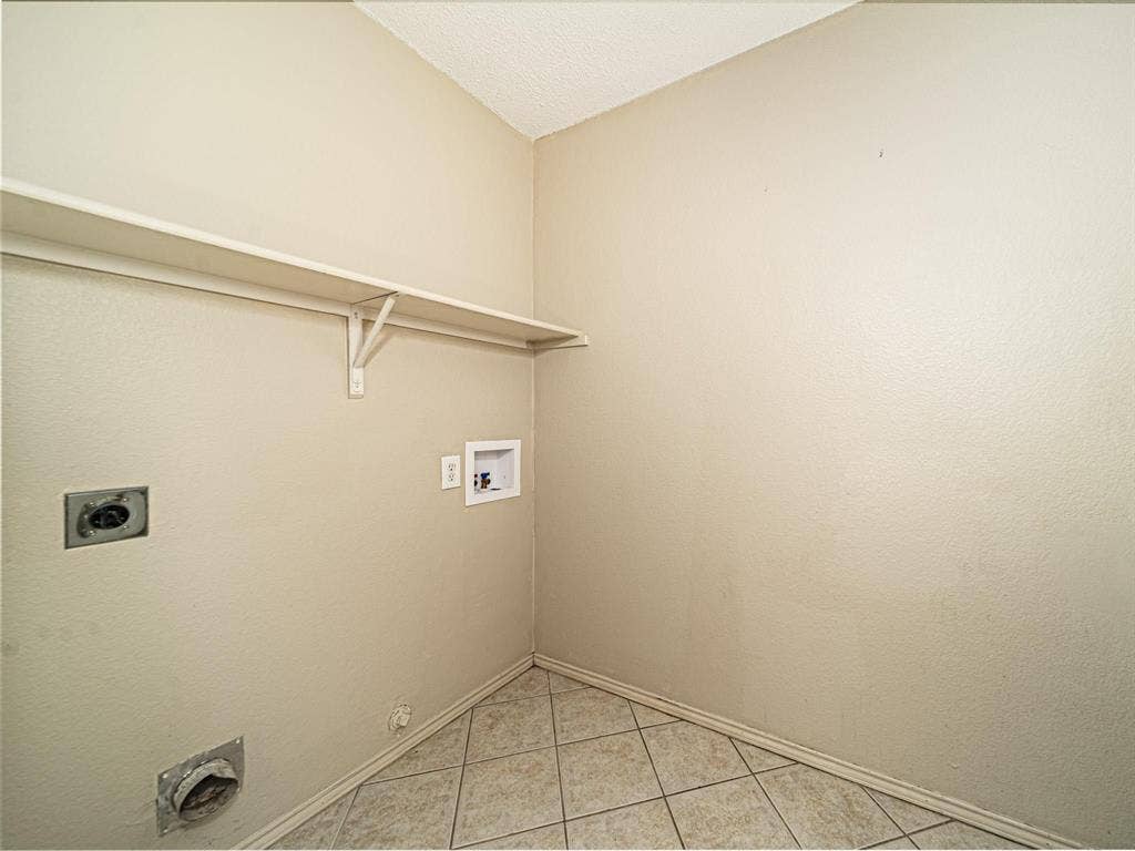 Built-in shelving unit, neutral wall paint, and tiled flooring