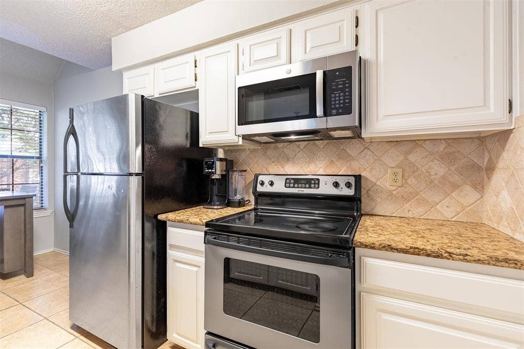 422 Santa Fe Trail, #11, Irving, TX 75063 White kitchen with stainless appliances.