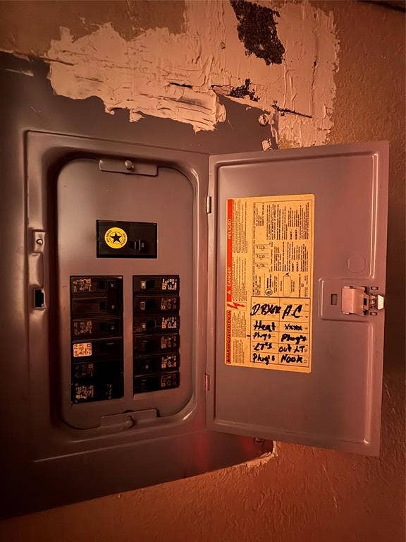 544 Pleasant Meadows Lane, Dallas, TX 75217 Wall-mounted circuit breaker panel featuring a labeled interior reference chart and multiple individual circuit breakers