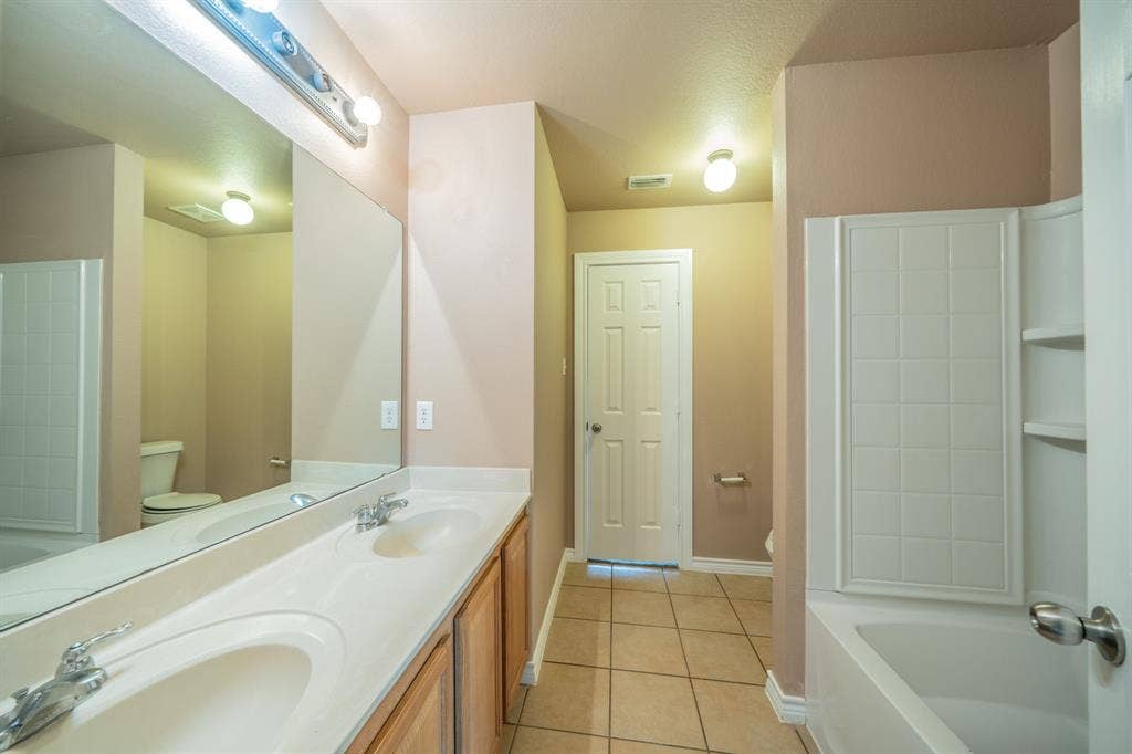 1739 Chadwick Drive, Cedar Hill, TX 75104 Upstairs jack and jill bathroom with dual sinks, built-in cabinets and granite countertop.