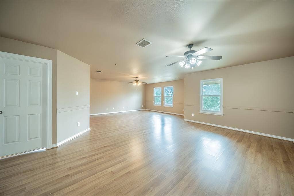 1739 Chadwick Drive, Cedar Hill, TX 75104 Large upstairs living area and game room with two ceiling fans.