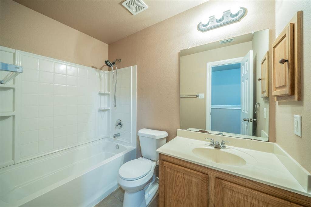 1739 Chadwick Drive, Cedar Hill, TX 75104 Second upstairs full bath with granite countertop, built-in cabinets and medicine cabinet.