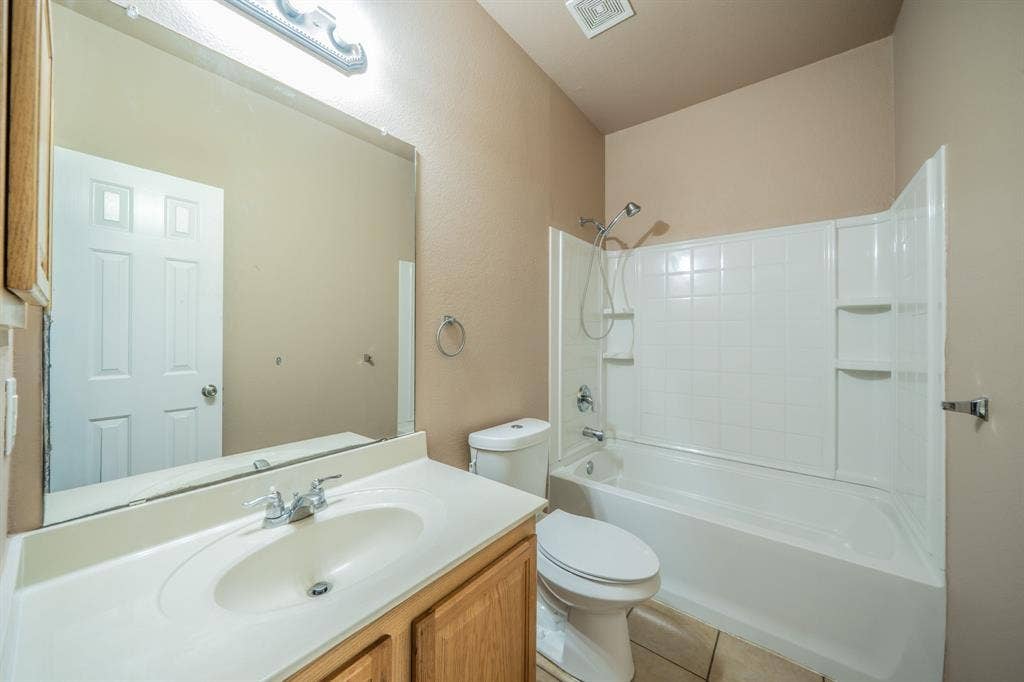 1739 Chadwick Drive, Cedar Hill, TX 75104 First floor full bath with built-in cabinets, granite countertop and medicine cabinet.