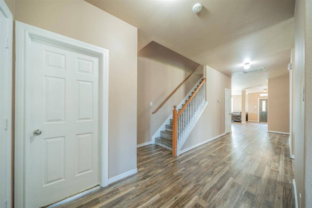 1739 Chadwick Drive, Cedar Hill, TX 75104 Entry hallway from kitchen area looking towards stairway and front door.