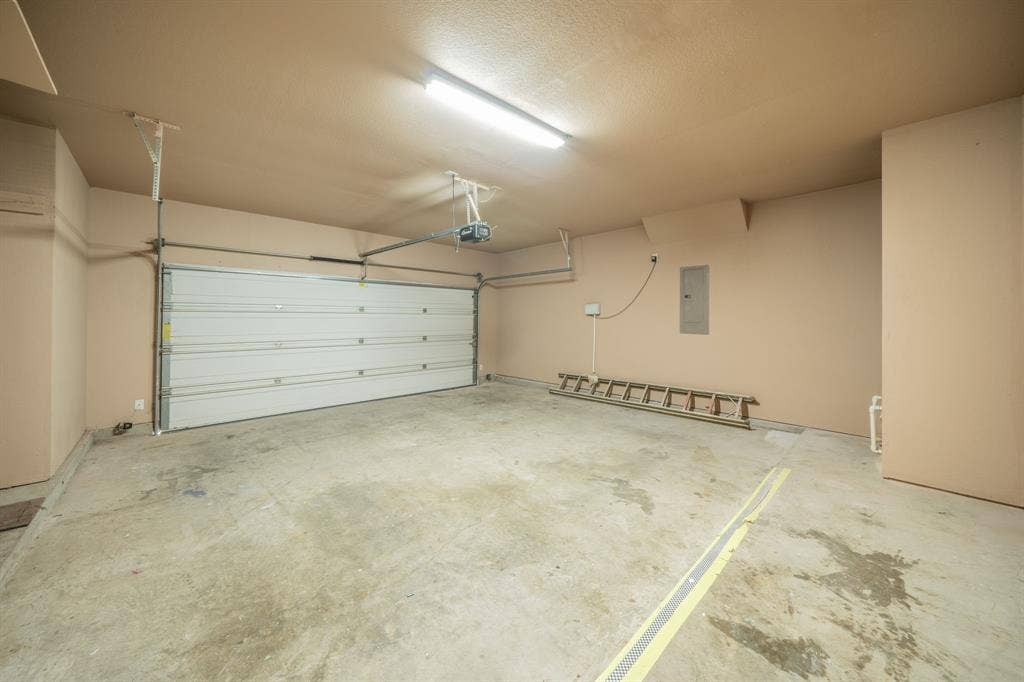 1739 Chadwick Drive, Cedar Hill, TX 75104 Two car garage that is 22 feet deep and 20 feet wide with 7 feet by 2 feet storage area to the left in this photo.