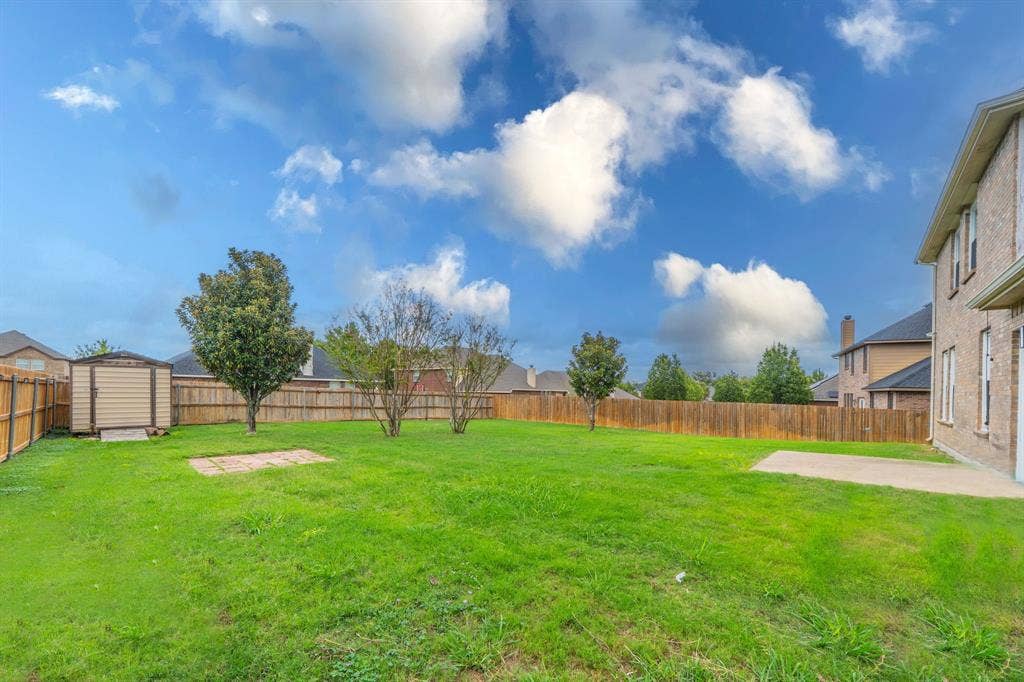 1739 Chadwick Drive, Cedar Hill, TX 75104 Backyard with view of 7.5' wide x 8' deep storage shed, 8' x 8' brick pavers for BBQ area or fire pit area, and concrete patio 12' wide and 10' deep.