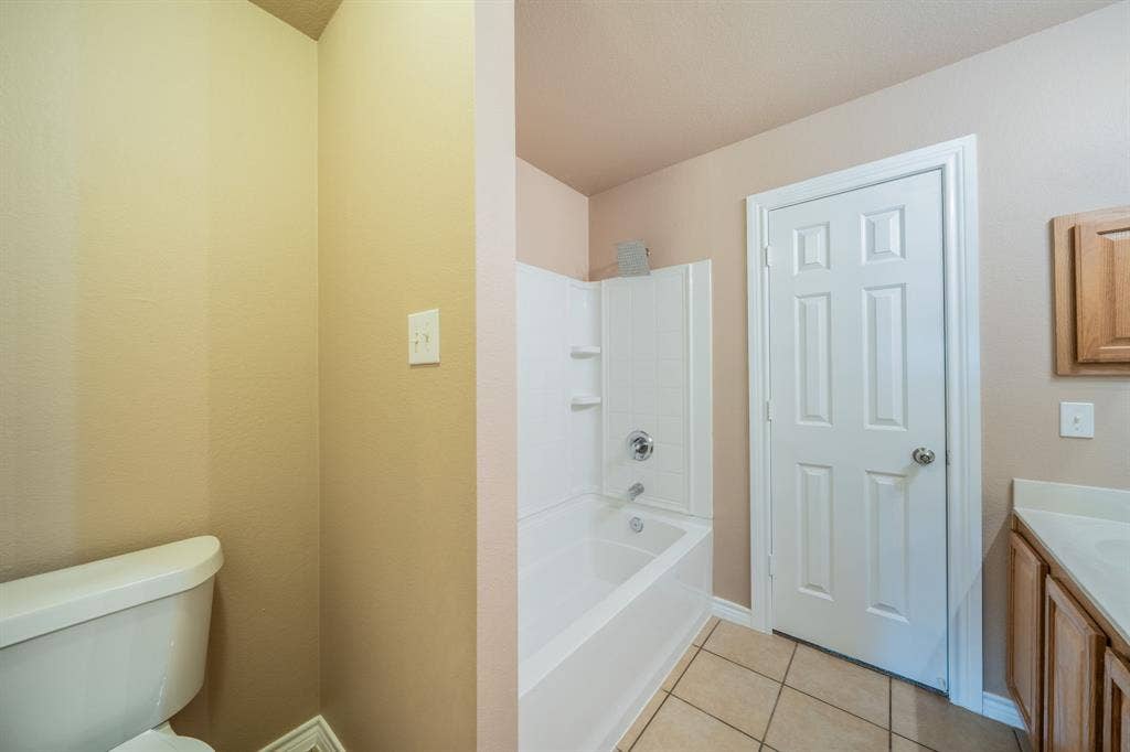 1739 Chadwick Drive, Cedar Hill, TX 75104 Upstairs jack and jill bathroom with built-in cabinets, medicine cabinet and granite countertop.