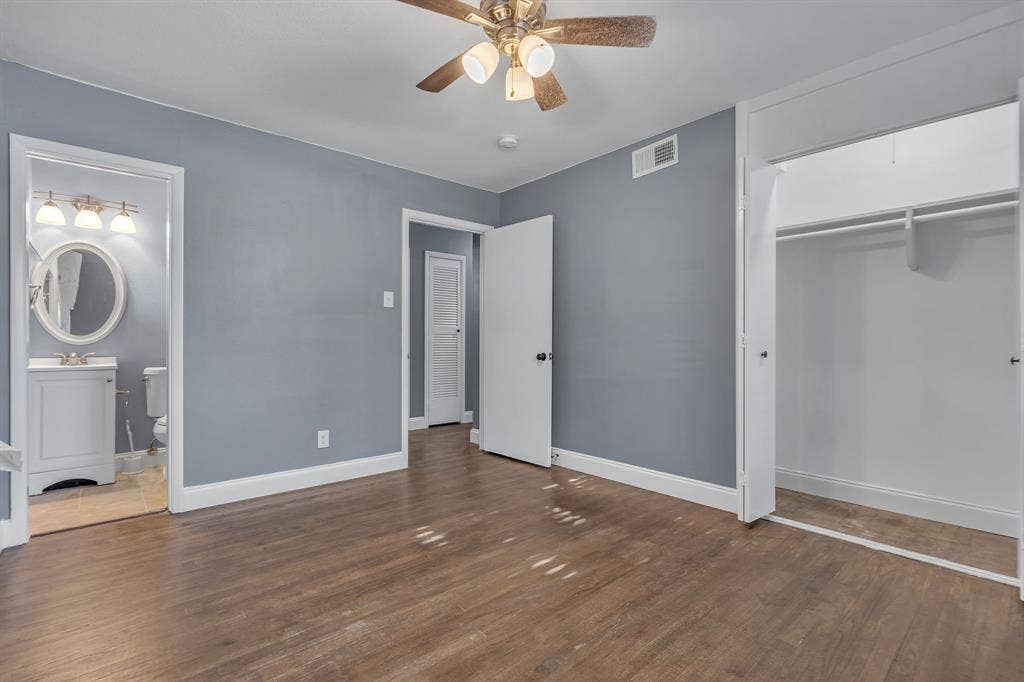 9621 Rustown Drive, Dallas, TX 75228 Wood-finish flooring, ceiling fan with integrated lighting, and an open closet with shelving