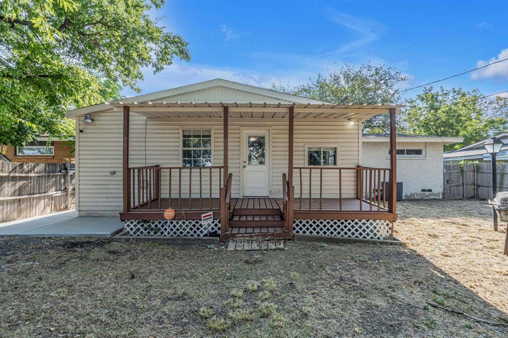 9621 Rustown Drive, Dallas, TX 75228 Rear exterior featuring a covered wood deck, vinyl siding, and a fenced yard