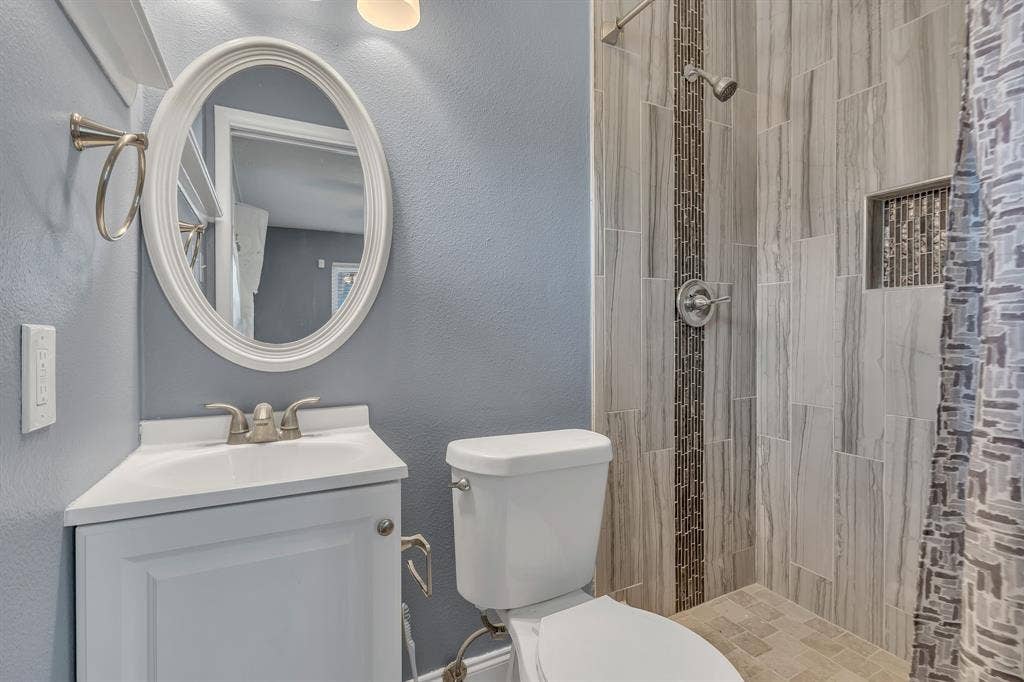 Corner vanity with an integrated sink and brushed nickel faucet