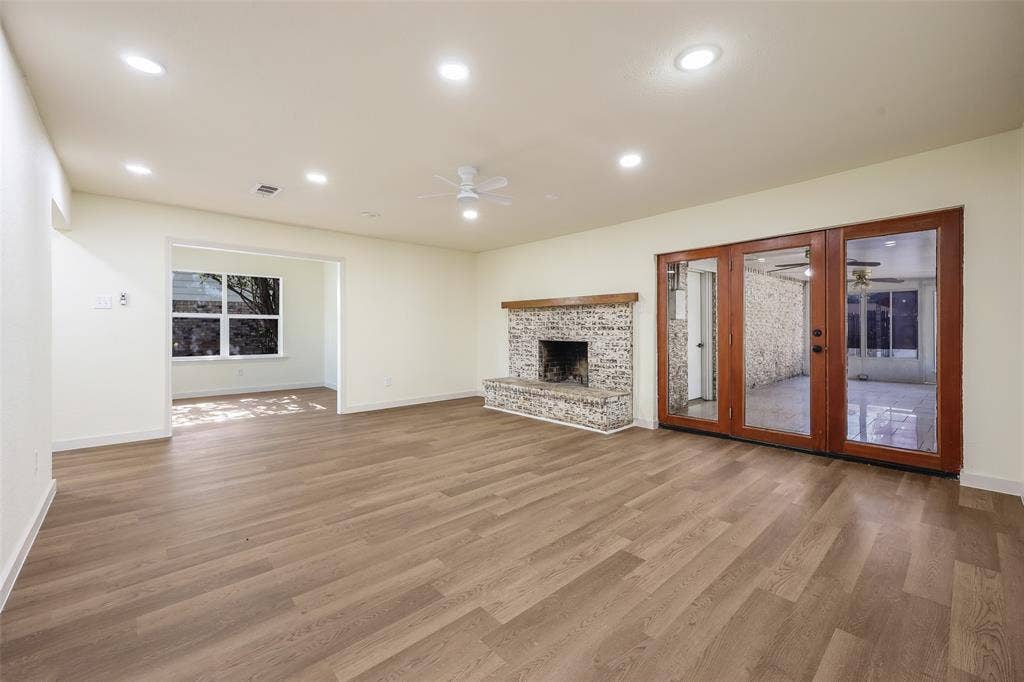Spacious room with wood-finish flooring, recessed lighting, and a ceiling fan