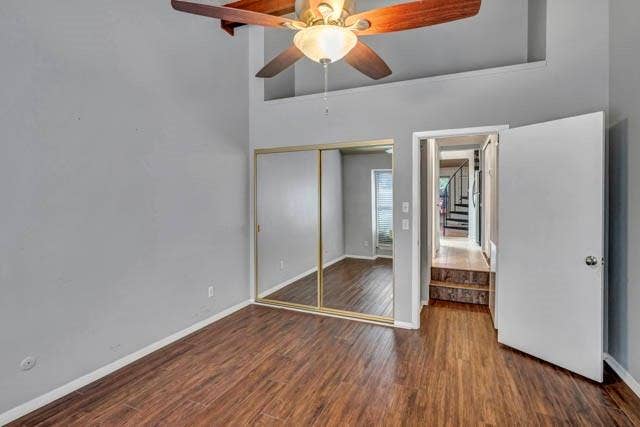 2503 Shady Ridge Drive, Bedford, TX 76021 High-ceiling interior featuring wood-finish flooring, a ceiling fan with integrated lighting, and a dual-panel mirrored closet