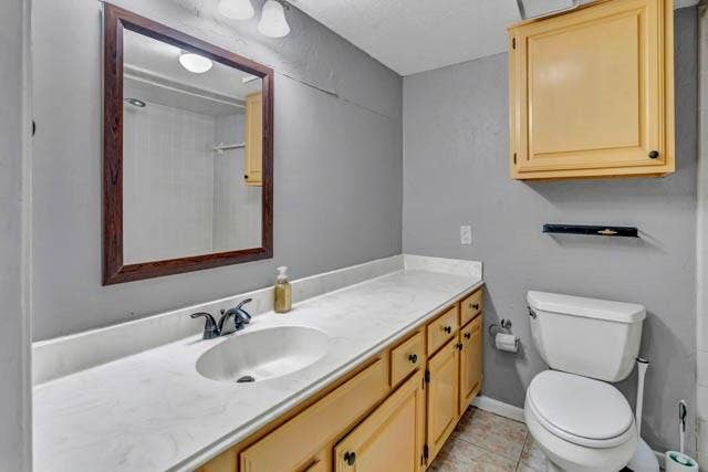 2503 Shady Ridge Drive, Bedford, TX 76021 Bathroom featuring an expansive vanity with solid-surface countertop, integrated basin, wood-finish cabinetry, matching wall-mounted storage cabinet, and framed mirror