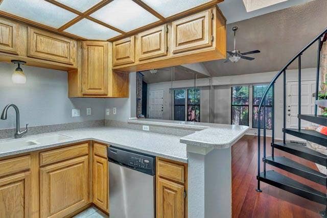 2503 Shady Ridge Drive, Bedford, TX 76021 Kitchen featuring wood cabinetry, stone-finish countertops, stainless steel dishwasher, coffered lighting, and a black metal spiral staircase