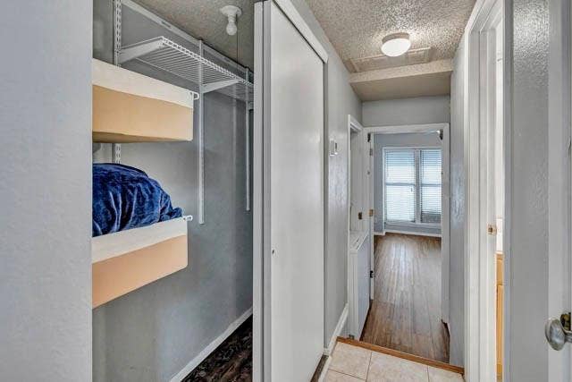 2503 Shady Ridge Drive, Bedford, TX 76021 Closet featuring wire shelving and white sliding doors, with wood-finish flooring and neutral wall paint