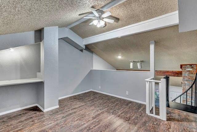 2503 Shady Ridge Drive, Bedford, TX 76021 Vaulted ceilings with exposed structural beams, wood-finish flooring, built-in shelving, white balustrade railing, and brick accent feature