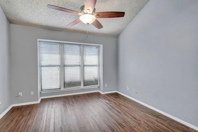 2503 Shady Ridge Drive, Bedford, TX 76021 Vaulted ceiling with integrated ceiling fan, wood-finish flooring, and a large triple-pane window with horizontal blinds