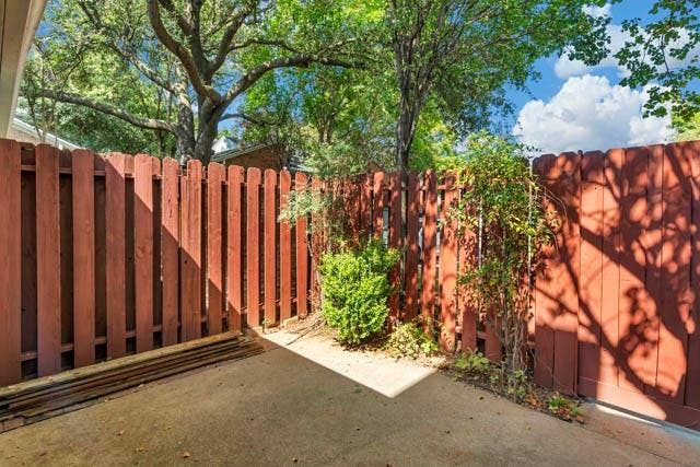 2503 Shady Ridge Drive, Bedford, TX 76021 Private outdoor area featuring a concrete patio, wood-slat perimeter fencing, and mature trees