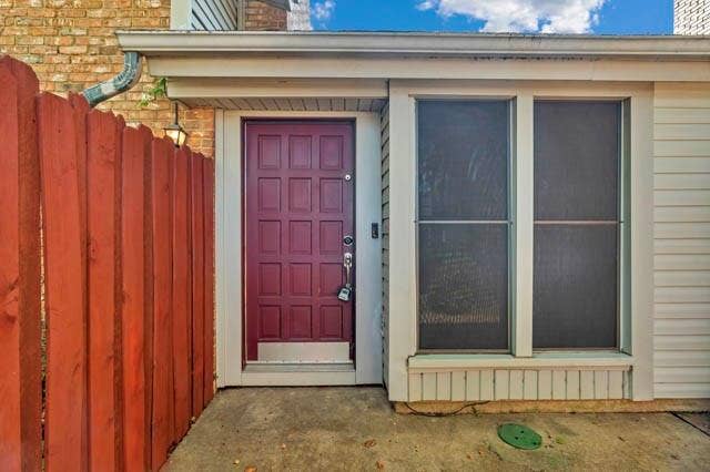 2503 Shady Ridge Drive, Bedford, TX 76021 Entry featuring a multi-panel door with a metal kick plate, paired with double windows and horizontal siding