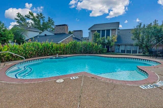 2503 Shady Ridge Drive, Bedford, TX 76021 In-ground pool with stone-texture decking, tile trim, and integrated step entry