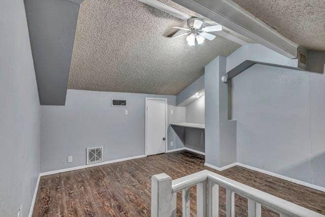 2503 Shady Ridge Drive, Bedford, TX 76021 Vaulted ceiling featuring a central lighted ceiling fan, wood-finish flooring, built-in desk area, and painted solid-core door