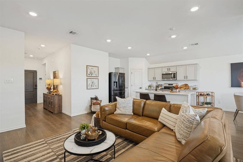 1506 Buckaroo Lane, Josephine, TX 75189 Open-concept interior featuring wood-finish flooring, recessed lighting, and a kitchen island with a neutral countertop